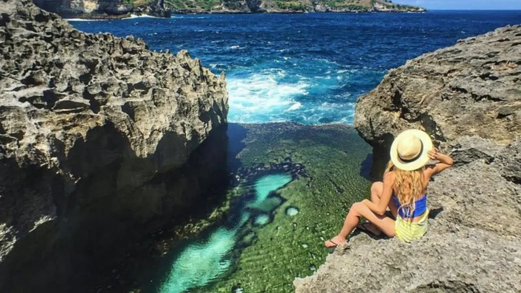 Close-up view of Angel Billabong Nusa Penida showcasing emerald-hued crystal clear water and natural rock pool formations during low tide, a must-visit destination with Axe Stone Fast Cruise fast boat service from Bali