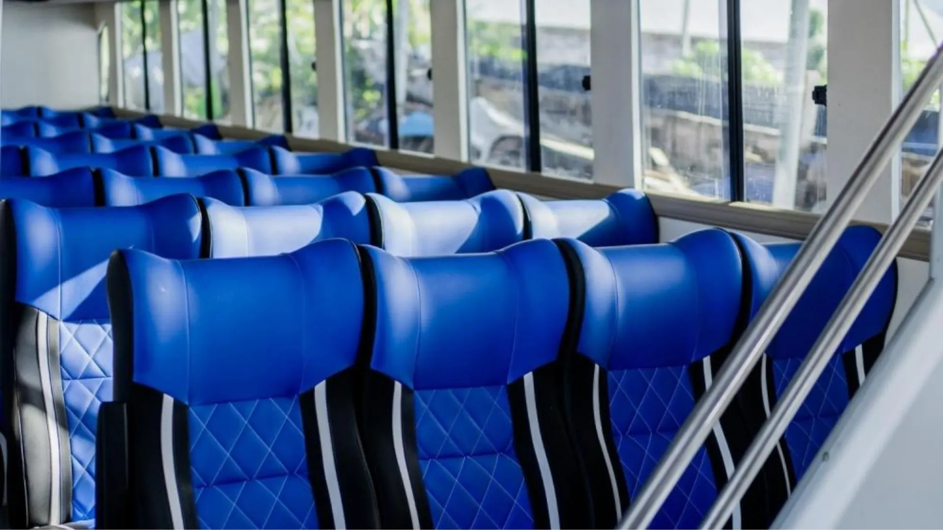 Blue comfortable seating aboard Axe Stone Dream during Fast Boat to Nusa Penida crossing with Axe Stone Fast Cruise, featuring cabin comfort.