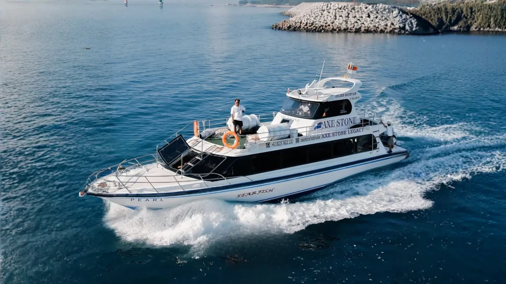 Axe Stone Legacy fast boat operated by Axe Stone Fast Cruise navigating Bali strait as premium Fast Boat Sanur to Nusa Penida service, featuring powerful engines and smooth ride