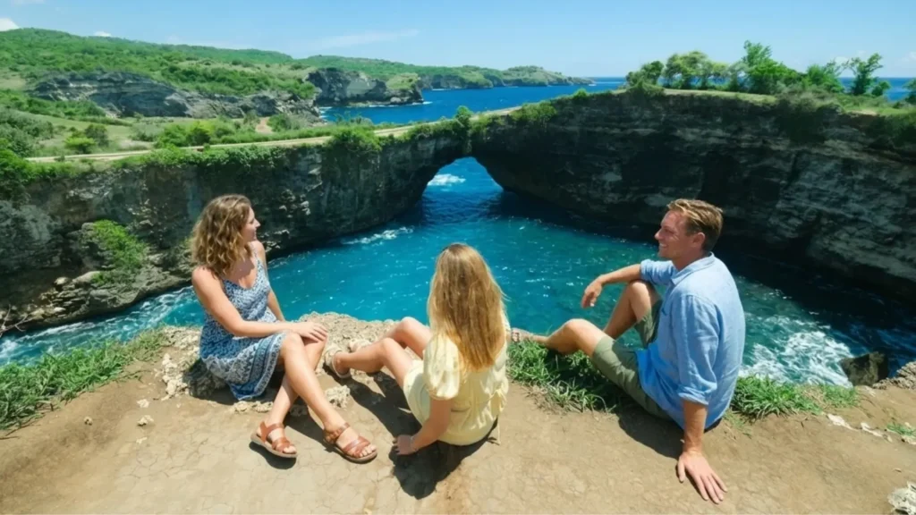 Iconic natural arch and turquoise lagoon at Broken Beach Nusa Penida showing seawater flowing through collapsed cave formation into circular cove, reachable with Axe Stone Fast Cruise fast boat service from Bali to Nusa Penida island