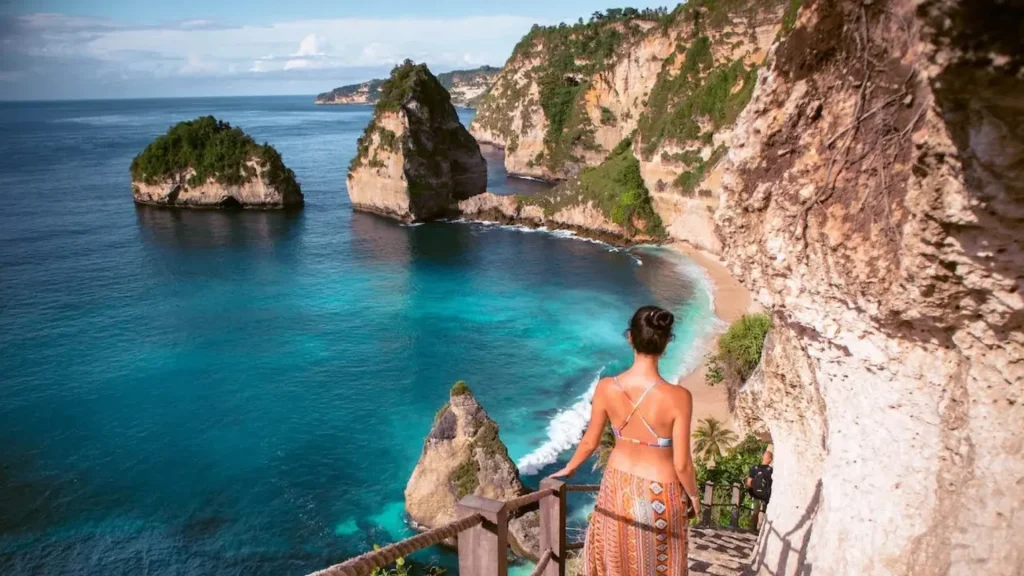 Adventurous cliff staircase with 166 steps and rope handrails descending to Diamond Beach Nusa Penida through rugged limestone cliffs, a challenging but rewarding access point for travelers booking East Nusa Penida Tour with Axe Stone Fast Cruise from Bali mainland