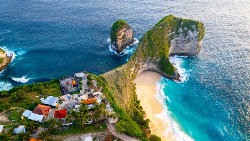 Iconic T-Rex shaped limestone cliff at Kelingking Beach Nusa Penida jutting into turquoise ocean with dramatic coastal panorama, the most photographed viewpoint in Nusa Penida accessible via Axe Stone Fast Cruise daily departures from Sanur Harbour to Banjar Nyuh Harbour for West Nusa Penida exploration
